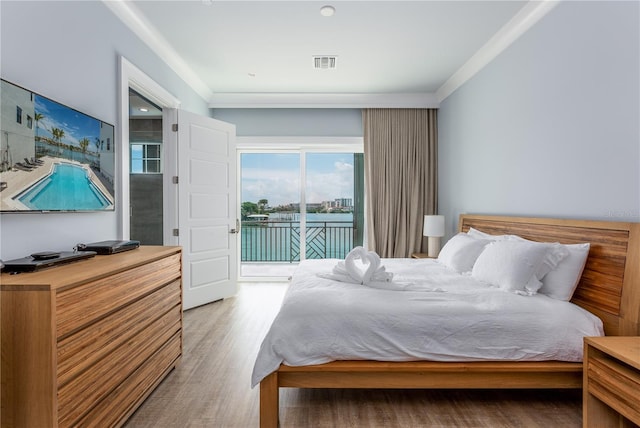 bedroom with wood-type flooring and access to outside