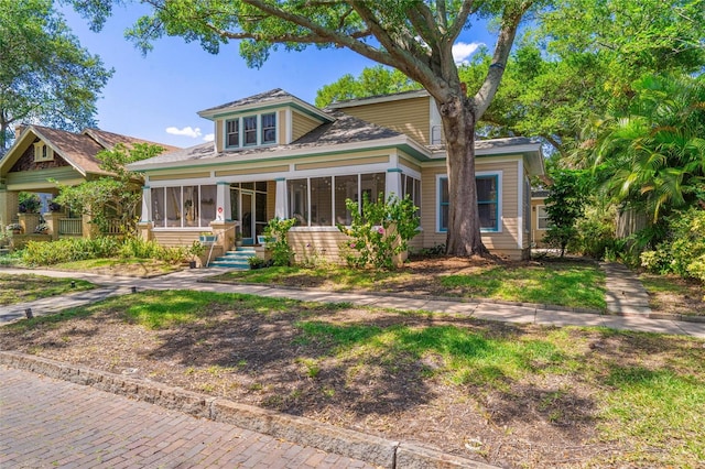 view of front facade with a sunroom