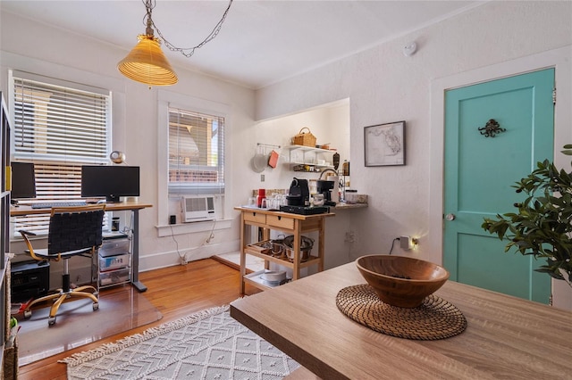 office space with wood-type flooring and cooling unit