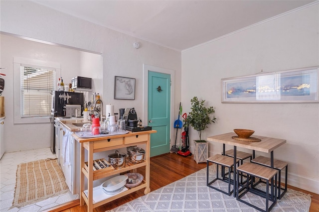 office area featuring sink, crown molding, and hardwood / wood-style floors