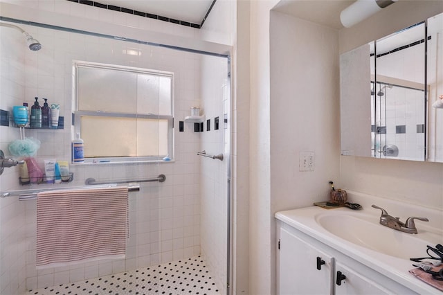 bathroom featuring walk in shower and vanity