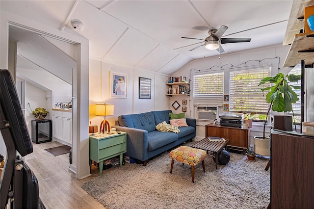 living room featuring light wood-type flooring, vaulted ceiling, and ceiling fan