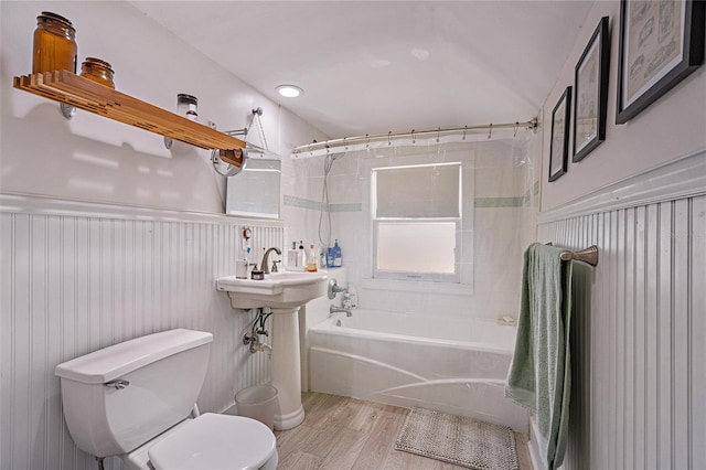 bathroom featuring hardwood / wood-style floors, toilet, and shower / bath combination with curtain