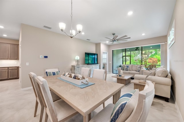 dining space featuring ceiling fan with notable chandelier and light tile patterned floors