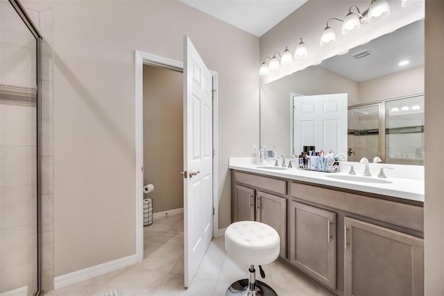 bathroom with tile patterned flooring, vanity, and an enclosed shower