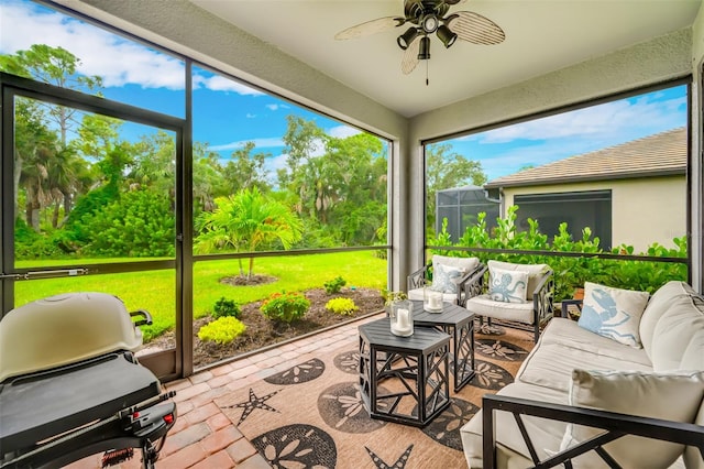 sunroom featuring ceiling fan