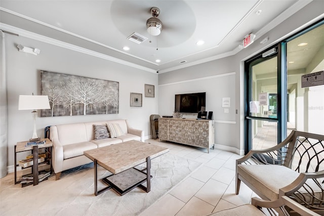 living room with light tile patterned floors, ornamental molding, ceiling fan, and a wealth of natural light