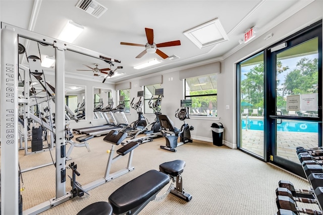 exercise room featuring ornamental molding, carpet, and ceiling fan