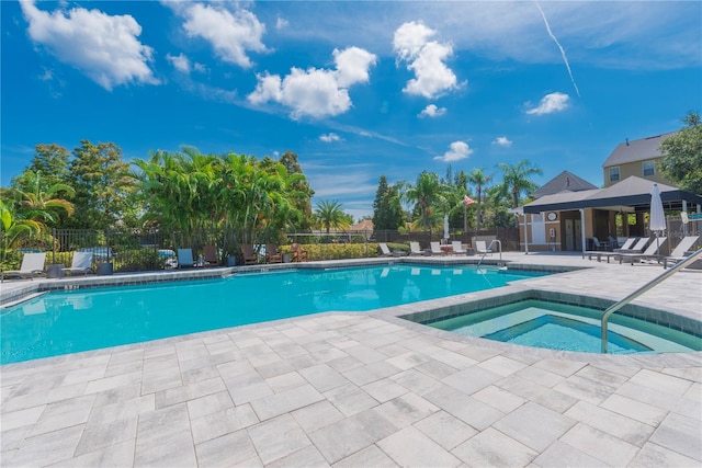 view of pool with a patio area and a hot tub