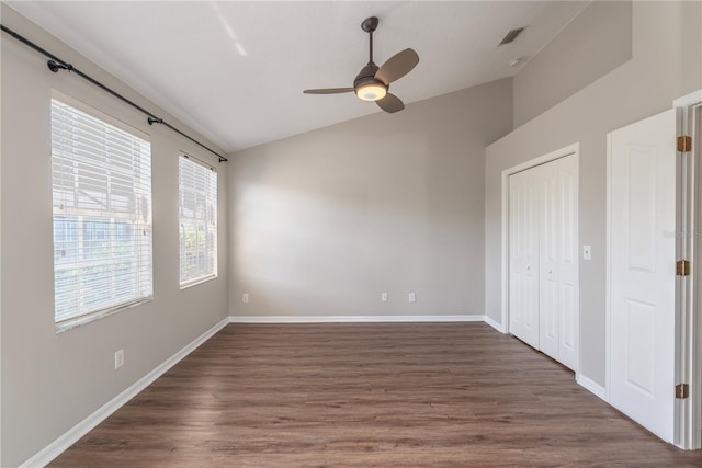 unfurnished room with ceiling fan, dark wood-type flooring, and lofted ceiling