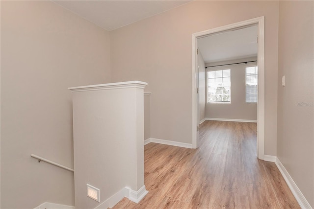 corridor with light hardwood / wood-style floors