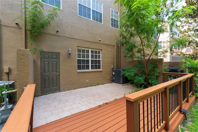 deck featuring cooling unit and a patio area