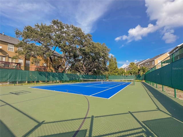 view of tennis court featuring basketball hoop