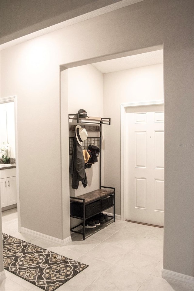 mudroom with sink and light tile patterned floors