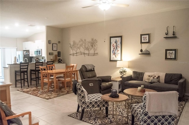 tiled living room featuring vaulted ceiling and ceiling fan