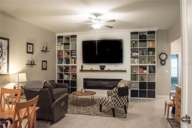 tiled living room featuring a textured ceiling and ceiling fan