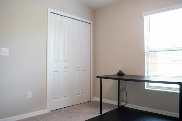 interior space featuring a closet and carpet floors