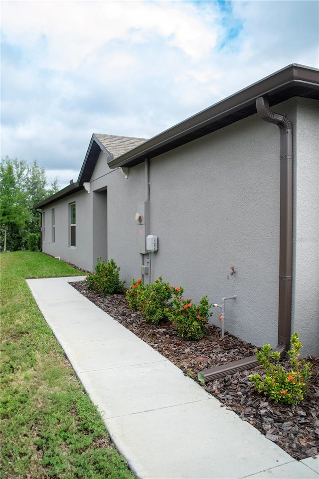 view of side of property with a yard