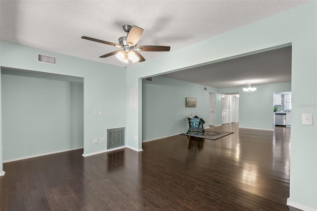 unfurnished living room with ceiling fan with notable chandelier, dark wood-type flooring, and a textured ceiling