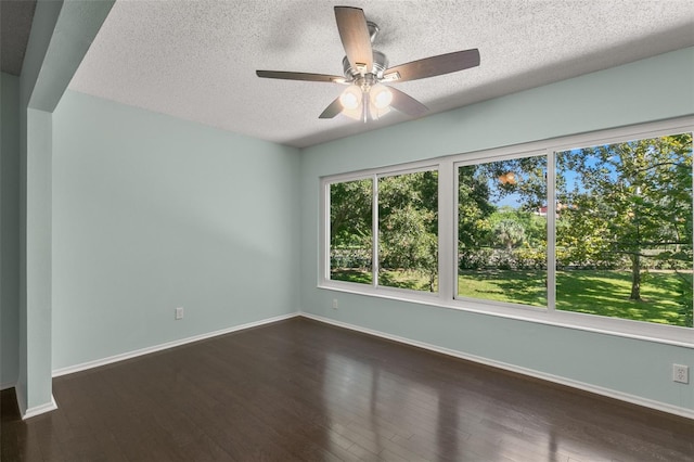 unfurnished room featuring ceiling fan, dark hardwood / wood-style flooring, and a textured ceiling