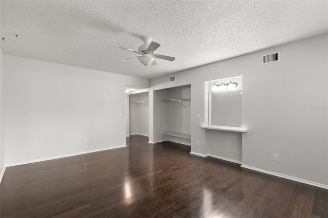 unfurnished bedroom with dark hardwood / wood-style flooring, ceiling fan, a closet, and a textured ceiling