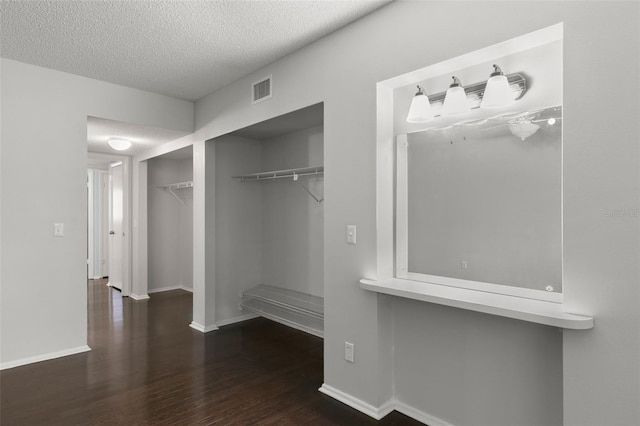 spacious closet featuring dark hardwood / wood-style floors