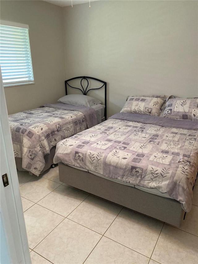 bedroom with light tile patterned floors