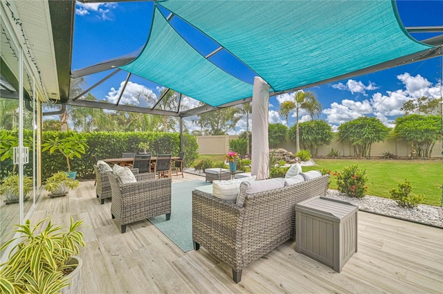 deck featuring a lawn, a lanai, and an outdoor hangout area