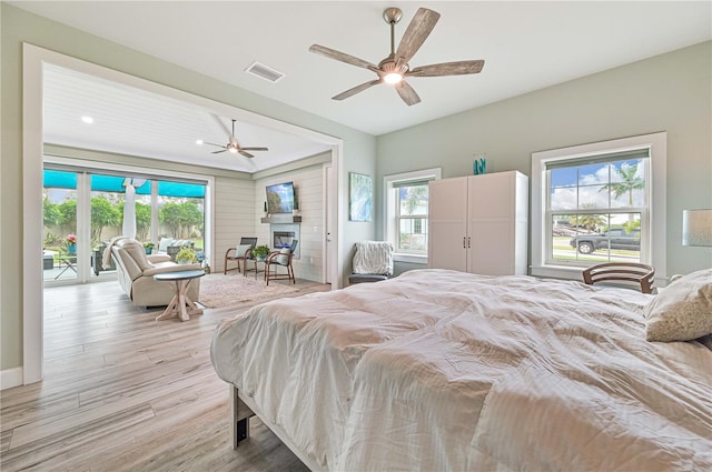 bedroom with ceiling fan, light hardwood / wood-style flooring, and access to exterior