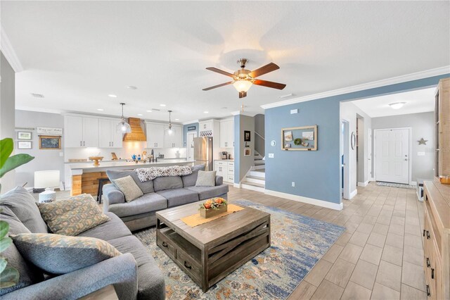 living room with ceiling fan, crown molding, and light hardwood / wood-style floors