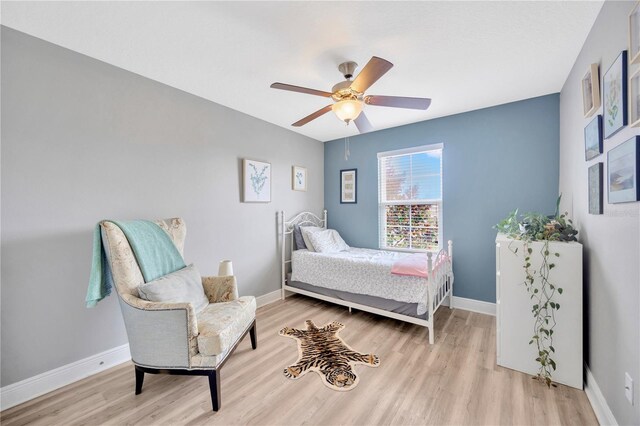 bedroom with ceiling fan and light hardwood / wood-style floors