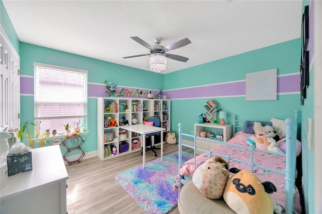 bedroom with light hardwood / wood-style flooring, a closet, and ceiling fan