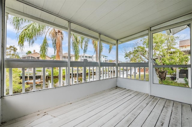 unfurnished sunroom with a water view