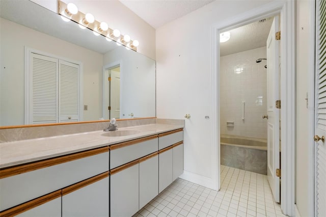 bathroom with tile patterned flooring, vanity, tiled shower / bath combo, and a textured ceiling