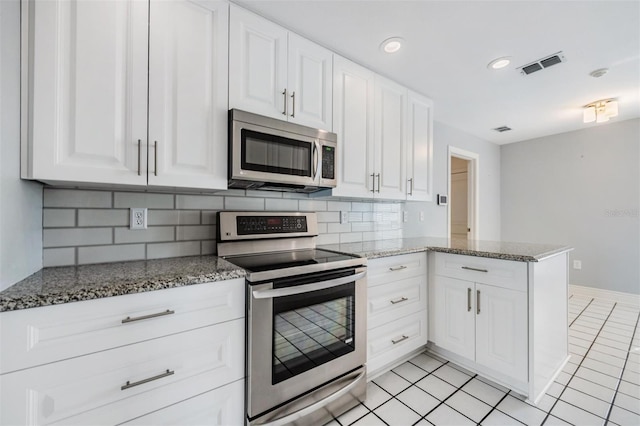 kitchen with kitchen peninsula, white cabinetry, and stainless steel appliances