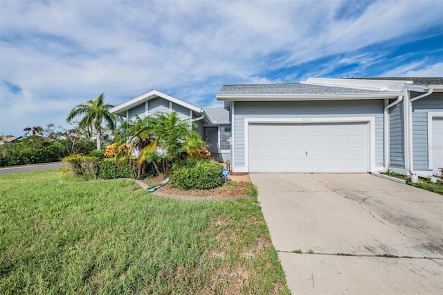 view of front of house featuring a front yard and a garage