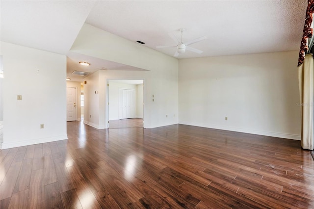 spare room featuring dark wood-type flooring and ceiling fan