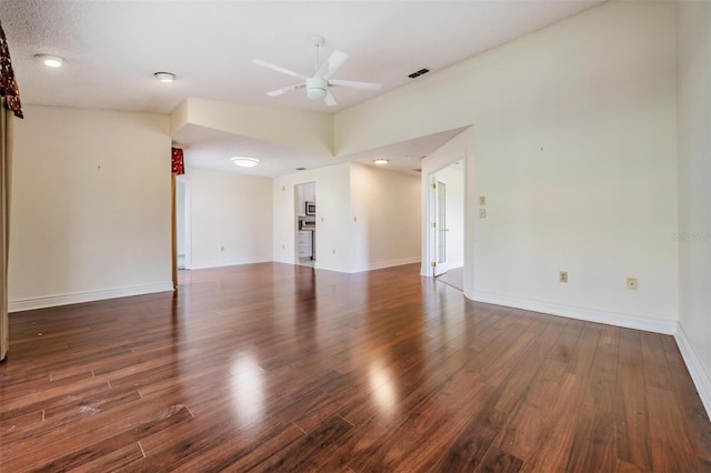 unfurnished room with ceiling fan and dark hardwood / wood-style floors