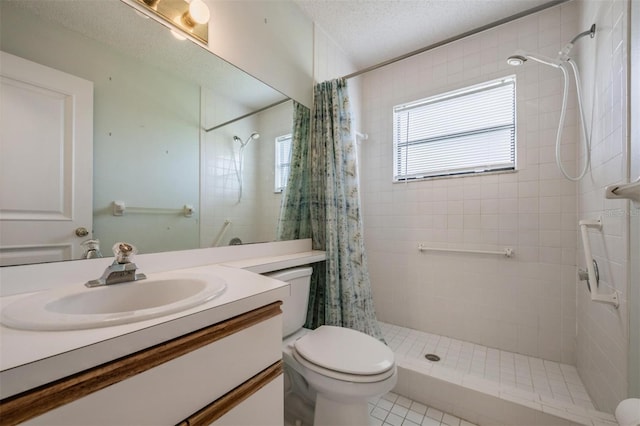 bathroom with vanity, curtained shower, toilet, and a textured ceiling