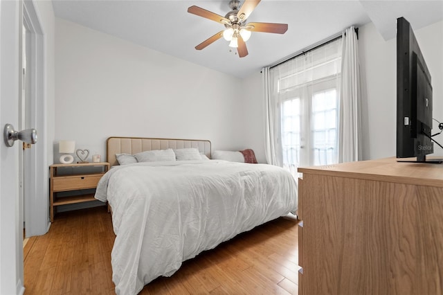 bedroom featuring ceiling fan, french doors, and light hardwood / wood-style floors