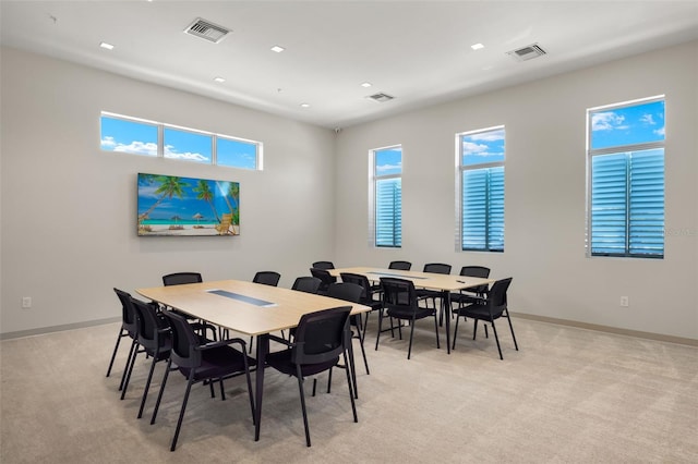 carpeted dining area with a healthy amount of sunlight