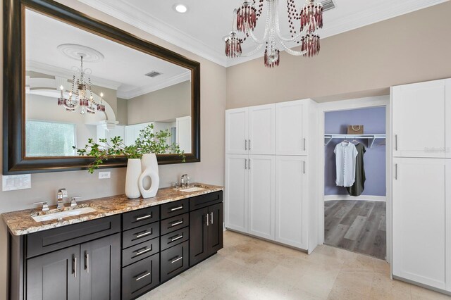 45 Adalia Ave, Tampa, FL 33606 - full bathroom with a chandelier, crown molding, double vanity, and a walk in closet