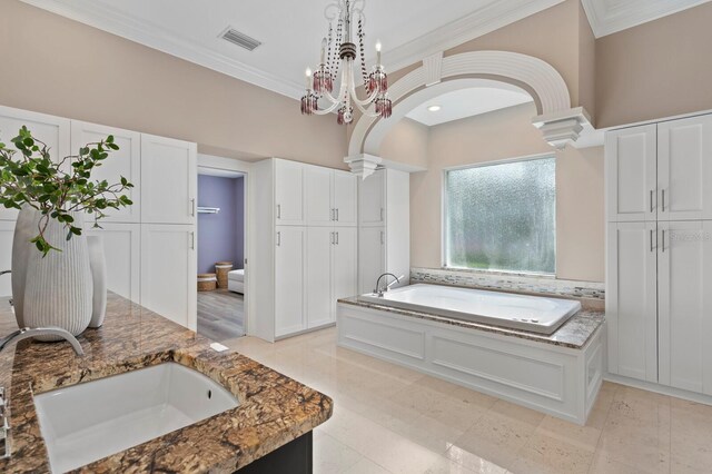 45 Adalia Ave, Tampa, FL 33606 - full bath featuring a bath, crown molding, vanity, tile patterned flooring, and a chandelier