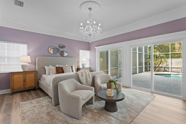 45 Adalia Ave, Tampa, FL 33606 - bedroom featuring access to exterior, light wood finished floors, a chandelier, and crown molding