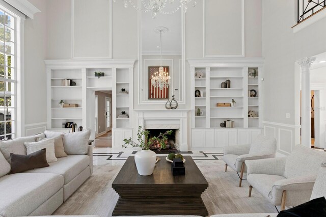 45 Adalia Ave, Tampa, FL 33606 - living area featuring a decorative wall, a chandelier, built in shelves, crown molding, and a high end fireplace
