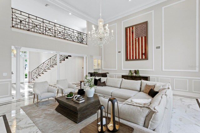 45 Adalia Ave, Tampa, FL 33606 - living room featuring a decorative wall, light marble finish flooring, stairs, decorative columns, and crown molding