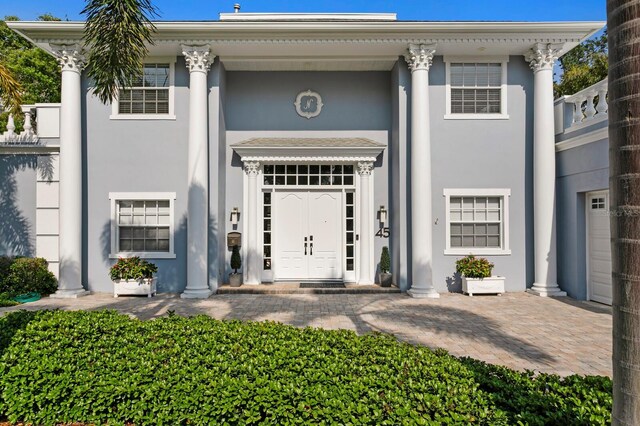 45 Adalia Ave, Tampa, FL 33606 - neoclassical home featuring stucco siding and a porch