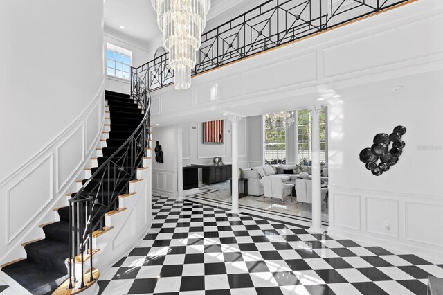 45 Adalia Ave, Tampa, FL 33606 - stairway with a decorative wall, a chandelier, crown molding, a towering ceiling, and recessed lighting