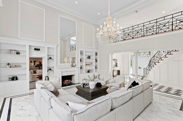 45 Adalia Ave, Tampa, FL 33606 - living room featuring light marble finish floors, built in shelves, a decorative wall, a high ceiling, and recessed lighting