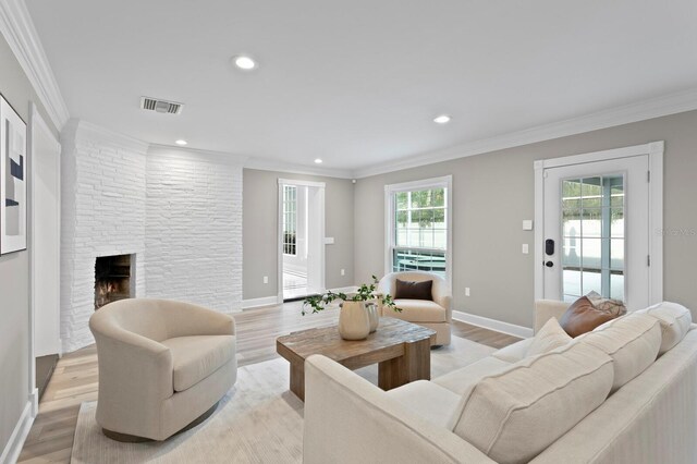 45 Adalia Ave, Tampa, FL 33606 - living room featuring light wood finished floors, ornamental molding, a brick fireplace, recessed lighting, and baseboards